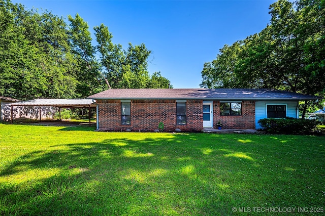 807 E Tahlequah, Sulphur, OK 73086 - view of front facade with brick siding, a detached carport, and a front lawn