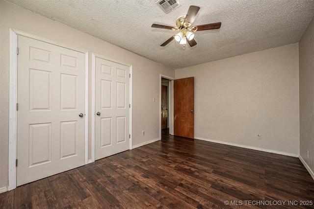 807 E Tahlequah, Sulphur, OK 73086 - unfurnished bedroom with dark wood-style flooring, a textured ceiling, and ceiling fan
