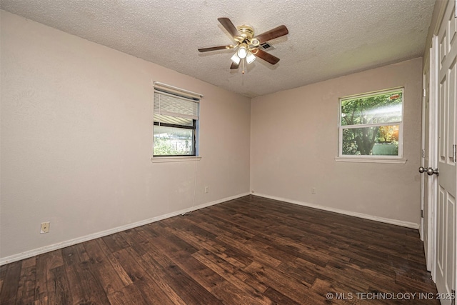 807 E Tahlequah, Sulphur, OK 73086 - empty room featuring healthy amount of natural light, dark wood-style flooring, a ceiling fan, and a textured ceiling