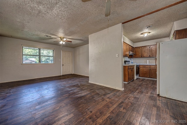 807 E Tahlequah, Sulphur, OK 73086 - kitchen featuring a ceiling fan, range with electric stovetop, freestanding refrigerator, a textured ceiling, and open floor plan