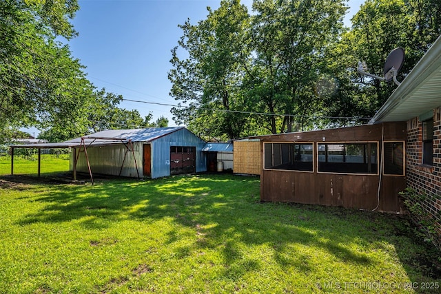 807 E Tahlequah, Sulphur, OK 73086 - view of green lawn with an outbuilding and a garage