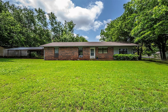 807 E Tahlequah, Sulphur, OK 73086 - view of front of home featuring a front lawn, a carport, and brick siding