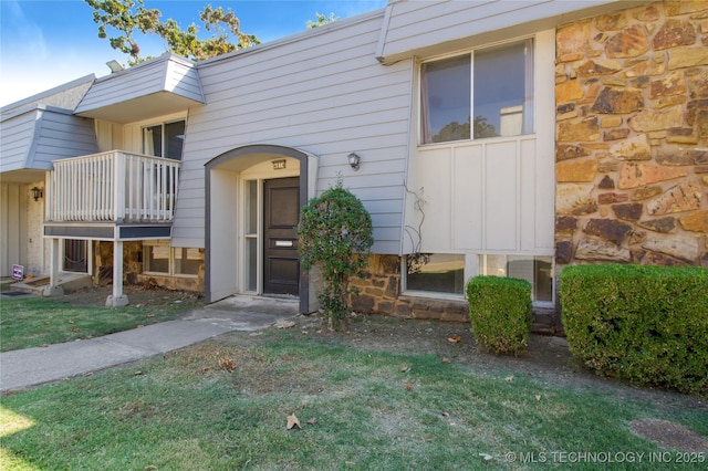 4814 E 68th St Unit 106, Tulsa, OK 74136 - entrance to property with stone siding and a balcony