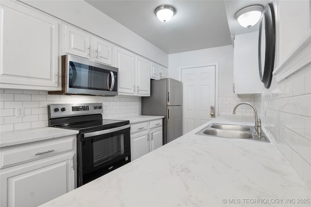 4814 E 68th St Unit 106, Tulsa, OK 74136 - kitchen with appliances with stainless steel finishes, white cabinets, and tasteful backsplash