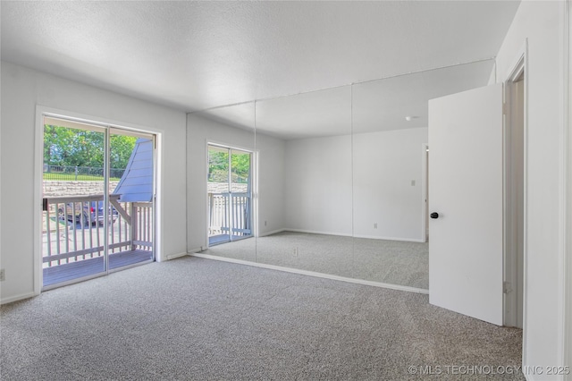 4814 E 68th St Unit 106, Tulsa, OK 74136 - spare room featuring carpet floors and a textured ceiling