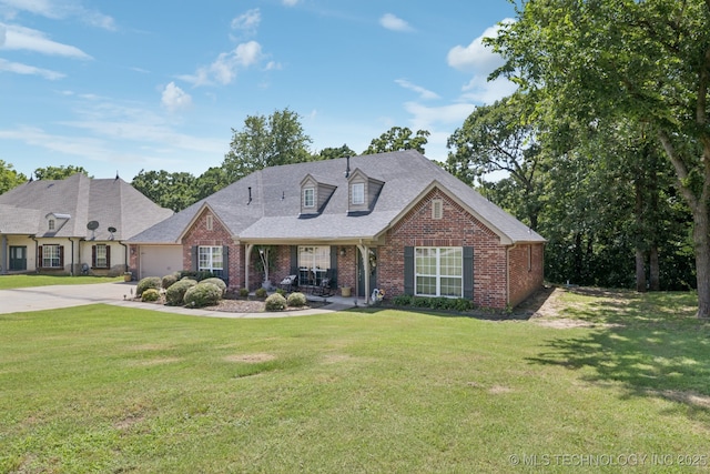 25070 S Red Oak Dr, Claremore, OK 74019 - view of front of property featuring brick siding, a front lawn, and driveway