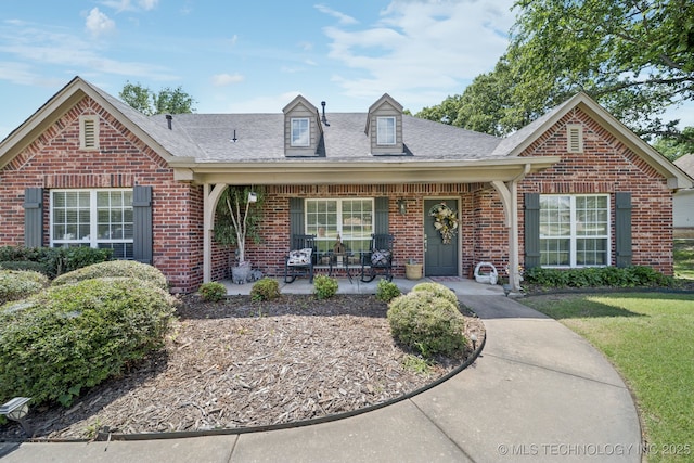 25070 S Red Oak Dr, Claremore, OK 74019 - view of front of property with brick siding, roof with shingles, a front lawn, and covered porch
