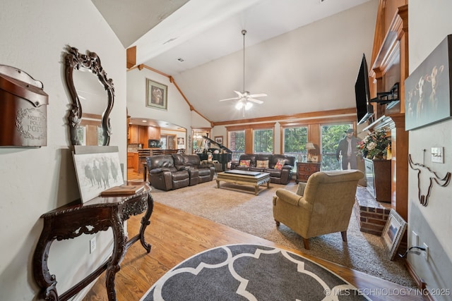 25070 S Red Oak Dr, Claremore, OK 74019 - living area featuring wood finished floors, ceiling fan, arched walkways, and high vaulted ceiling