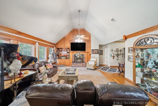 25070 S Red Oak Dr, Claremore, OK 74019 - living room featuring lofted ceiling, a ceiling fan, wood finished floors, and a fireplace