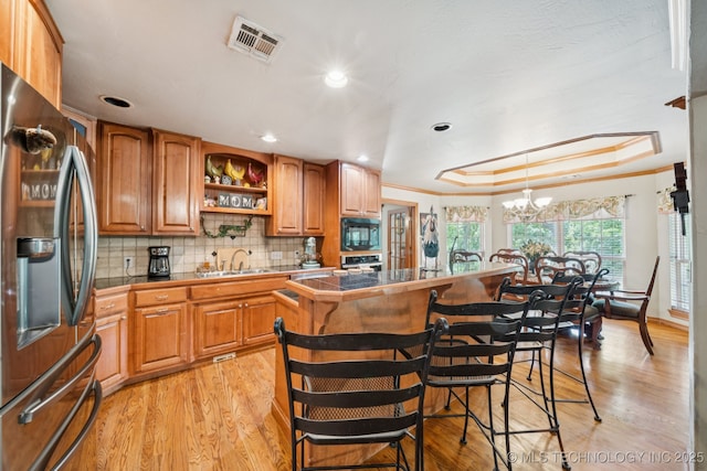 25070 S Red Oak Dr, Claremore, OK 74019 - kitchen featuring stainless steel appliances, light wood finished floors, open shelves, a chandelier, and a center island