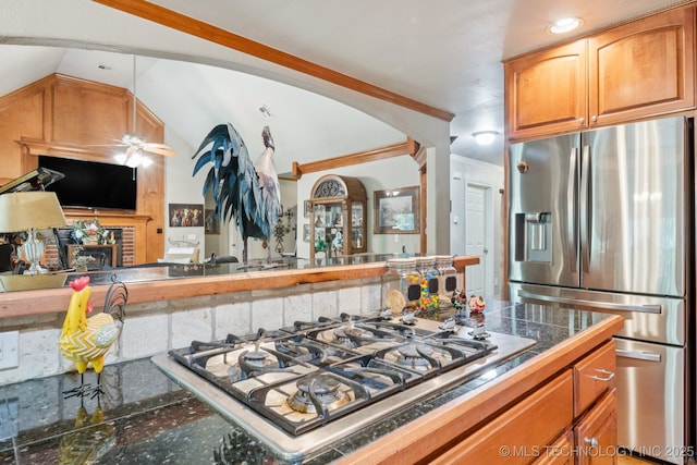 25070 S Red Oak Dr, Claremore, OK 74019 - kitchen with stainless steel appliances, ceiling fan, lofted ceiling, and a fireplace