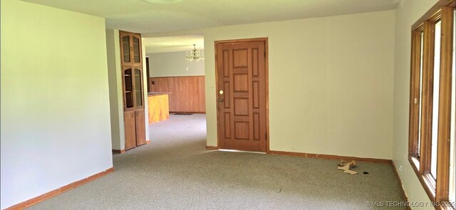 514 W Wichita Ave, Cleveland, OK 74020 - carpeted empty room with a chandelier and wainscoting