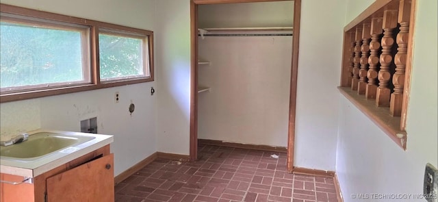 514 W Wichita Ave, Cleveland, OK 74020 - laundry room with brick patterned floors and baseboards