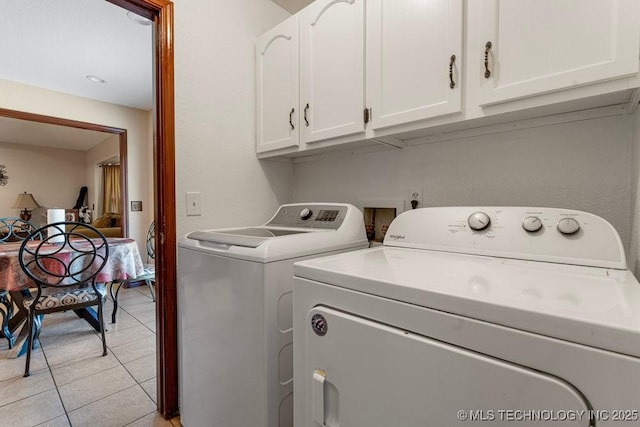 12915 S 120th E Pl, Tulsa, OK 74011 - washroom featuring washer and clothes dryer, cabinet space, and light tile patterned floors
