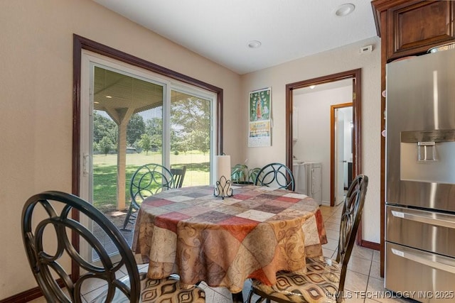 12915 S 120th E Pl, Tulsa, OK 74011 - dining area with separate washer and dryer and light tile patterned floors