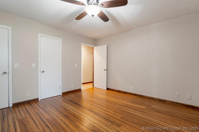 12915 S 120th E Pl, Tulsa, OK 74011 - unfurnished bedroom with wood finished floors and a ceiling fan