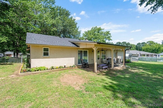 12915 S 120th E Pl, Tulsa, OK 74011 - rear view of property with brick siding, a patio area, a fenced backyard, a ceiling fan, and a shingled roof