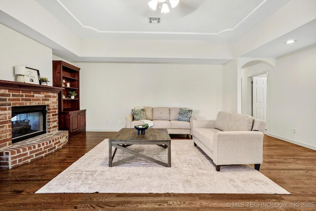 13718 S 262nd E Ave, Coweta, OK 74429 - living room featuring wood finished floors, arched walkways, ceiling fan, a raised ceiling, and recessed lighting