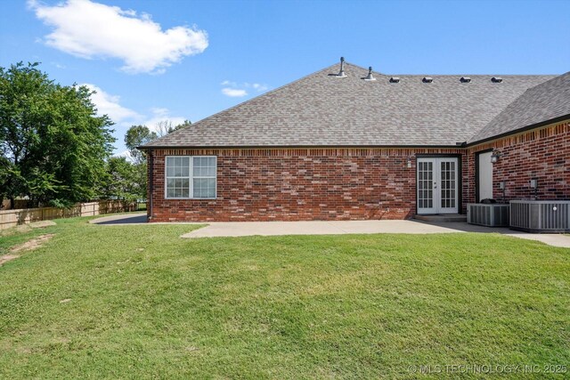 13718 S 262nd E Ave, Coweta, OK 74429 - back of property with french doors, a shingled roof, a patio, and brick siding