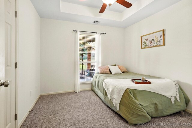 13718 S 262nd E Ave, Coweta, OK 74429 - carpeted bedroom with a tray ceiling and a ceiling fan
