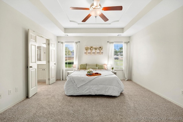 13718 S 262nd E Ave, Coweta, OK 74429 - bedroom featuring a raised ceiling, light colored carpet, ceiling fan, and ensuite bath