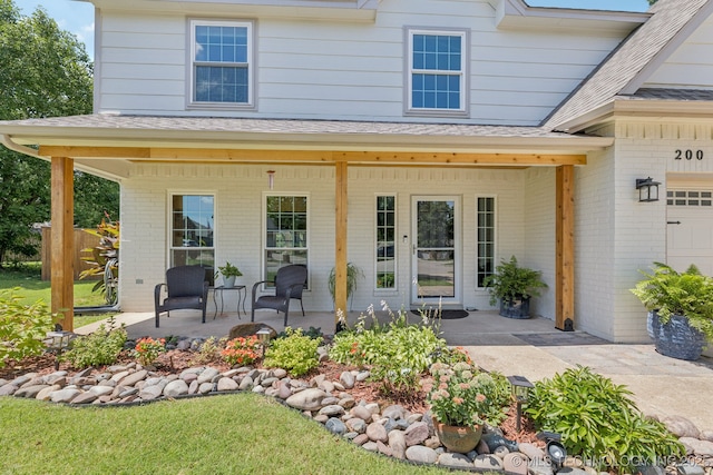 200 N Redwood Ct, Broken Arrow, OK 74012 - entrance to property with covered porch, brick siding, and roof with shingles