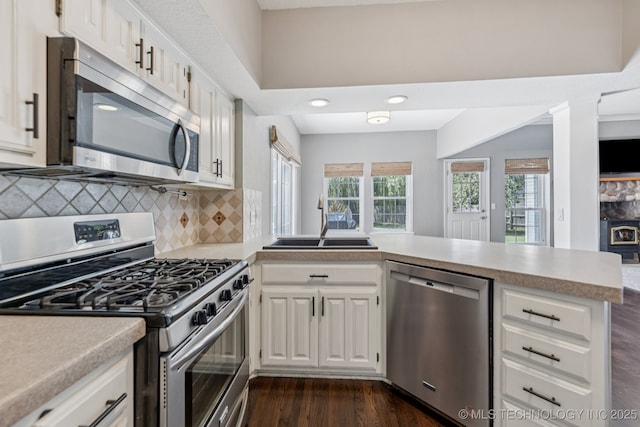 200 N Redwood Ct, Broken Arrow, OK 74012 - kitchen with appliances with stainless steel finishes, light countertops, healthy amount of natural light, and dark wood-style flooring