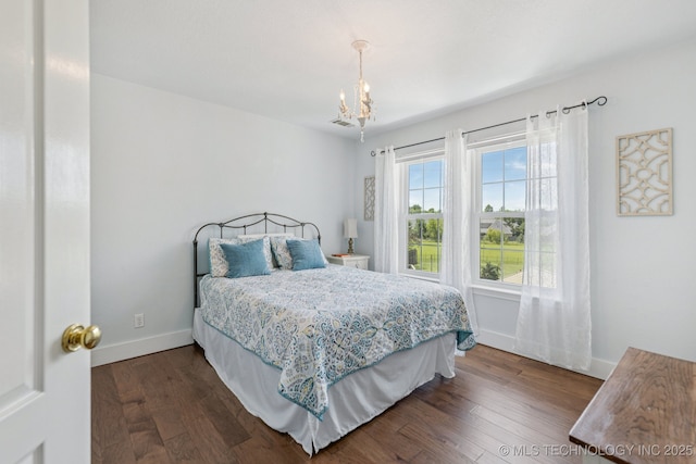 200 N Redwood Ct, Broken Arrow, OK 74012 - bedroom with a chandelier and dark wood finished floors