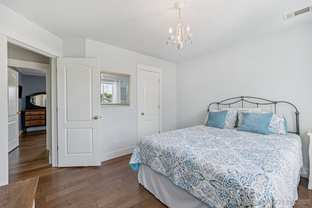 200 N Redwood Ct, Broken Arrow, OK 74012 - bedroom with dark wood-type flooring and a chandelier