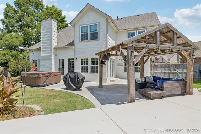 200 N Redwood Ct, Broken Arrow, OK 74012 - back of property with a hot tub, a gazebo, a patio, a chimney, and roof with shingles