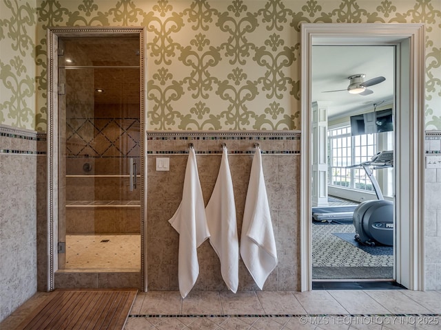 34159 E 698th Rd, Wagoner, OK 74467 - full bath featuring wallpapered walls, a shower stall, a wainscoted wall, ceiling fan, and tile patterned flooring