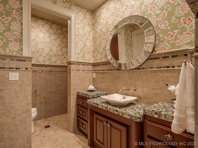 34159 E 698th Rd, Wagoner, OK 74467 - bathroom with vanity, tile walls, wallpapered walls, wainscoting, and tile patterned floors