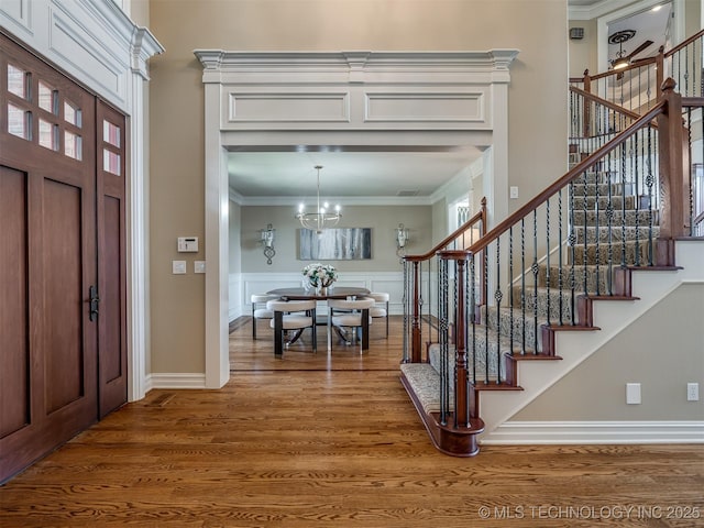 34159 E 698th Rd, Wagoner, OK 74467 - entryway featuring wood finished floors, stairway, a chandelier, ornamental molding, and a high ceiling