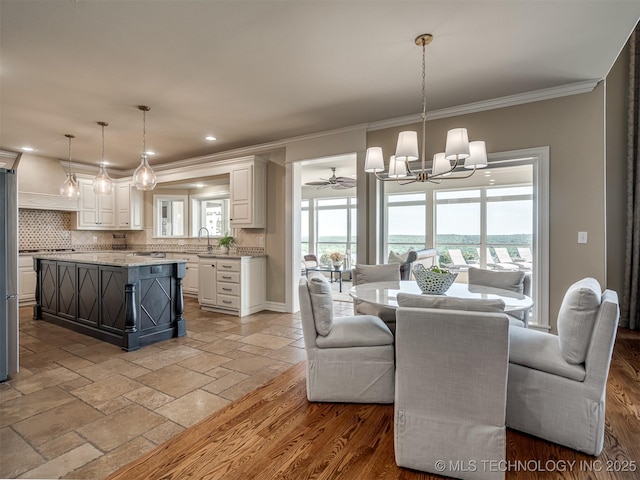 34159 E 698th Rd, Wagoner, OK 74467 - dining space featuring crown molding, a chandelier, stone tile floors, recessed lighting, and ceiling fan