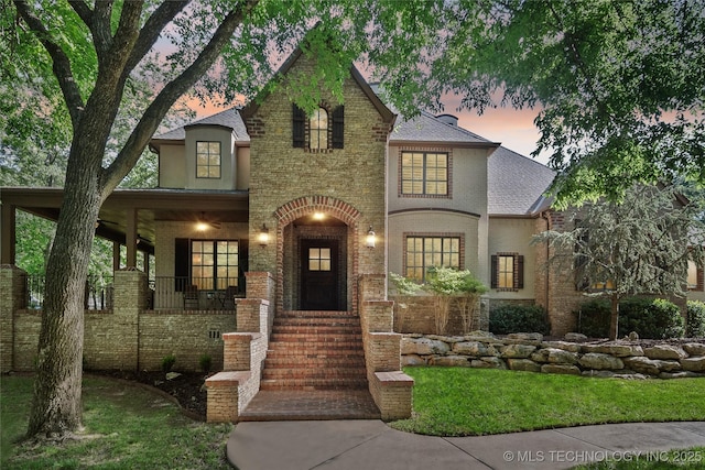 19735 E Woodhaven Rd, Owasso, OK 74055 - french country inspired facade with brick siding, covered porch, roof with shingles, and a yard