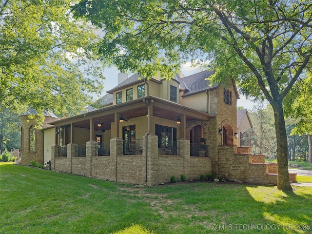 19735 E Woodhaven Rd, Owasso, OK 74055 - rear view of property featuring a lawn, a chimney, a ceiling fan, stucco siding, and stone siding