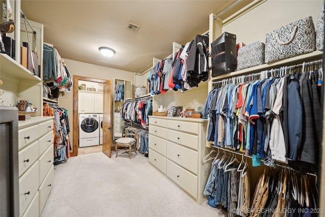 19735 E Woodhaven Rd, Owasso, OK 74055 - walk in closet featuring washing machine and clothes dryer and light carpet
