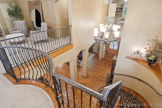 19735 E Woodhaven Rd, Owasso, OK 74055 - stairs with a chandelier and wood finished floors