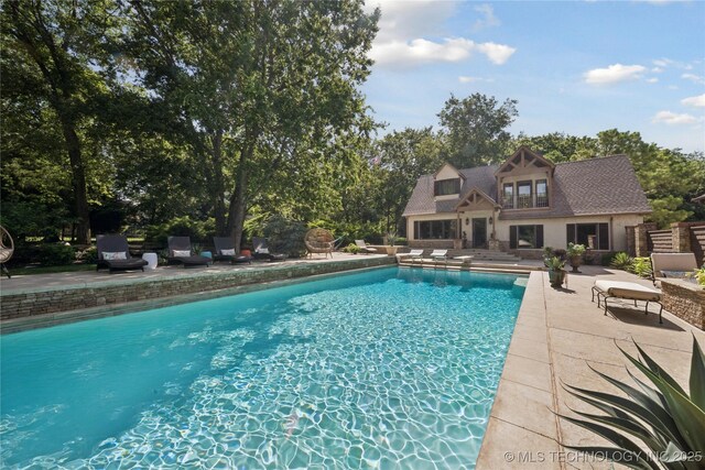19735 E Woodhaven Rd, Owasso, OK 74055 - outdoor pool with a patio and view of scattered trees
