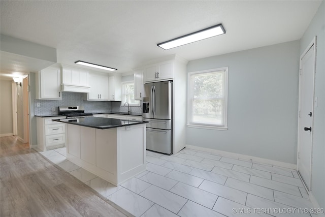 6240 E Latimer Pl, Tulsa, OK 74115 - kitchen featuring stainless steel appliances, custom exhaust hood, dark countertops, and plenty of natural light
