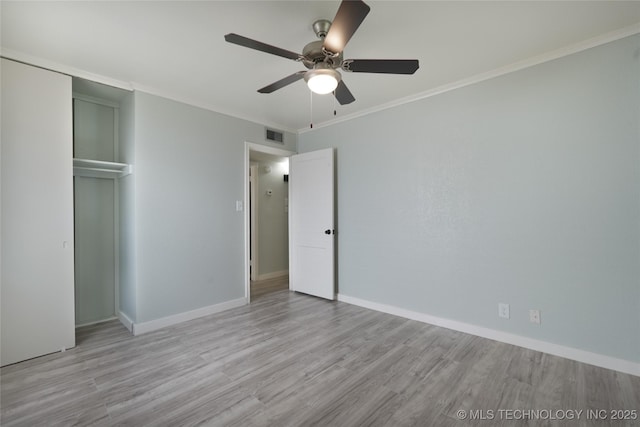 6240 E Latimer Pl, Tulsa, OK 74115 - unfurnished bedroom featuring a closet, wood finished floors, a ceiling fan, and crown molding
