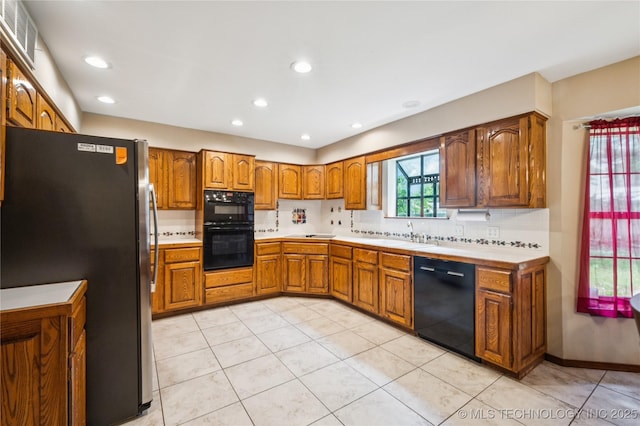 7222 E 87th St, Tulsa, OK 74133 - kitchen with black appliances, brown cabinetry, light countertops, backsplash, and recessed lighting