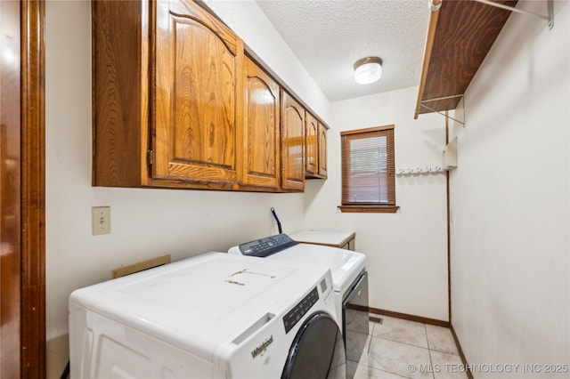 7222 E 87th St, Tulsa, OK 74133 - laundry room with separate washer and dryer, cabinet space, a textured ceiling, and light tile patterned floors