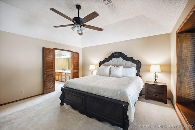 7222 E 87th St, Tulsa, OK 74133 - bedroom featuring light carpet, vaulted ceiling, a textured ceiling, connected bathroom, and a ceiling fan