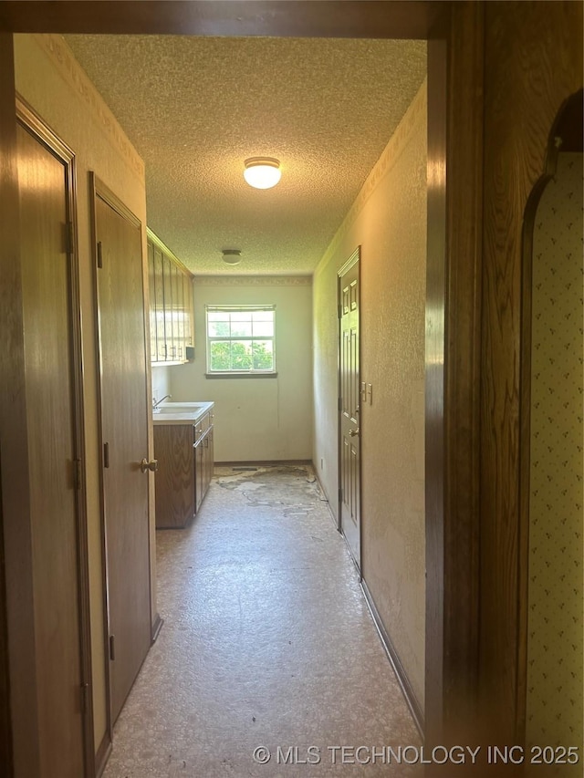 282 Westland Rd, Sapulpa, OK 74066 - hall featuring a textured ceiling and a sink