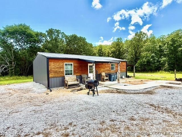 105148 S 4500, Vian, OK 74962 - rear view of house featuring entry steps and a metal roof