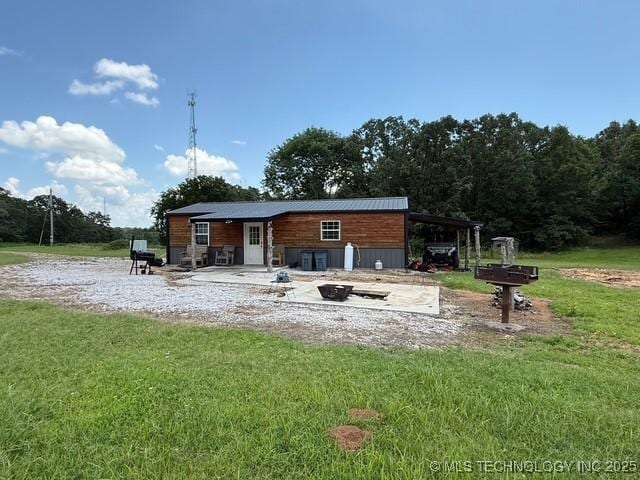 105148 S 4500, Vian, OK 74962 - rear view of house with a lawn and a fire pit