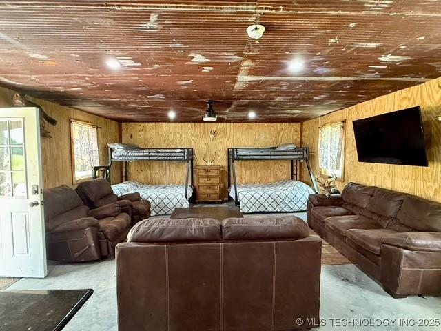 105148 S 4500, Vian, OK 74962 - living room with plenty of natural light, wood walls, wooden ceiling, and finished concrete floors