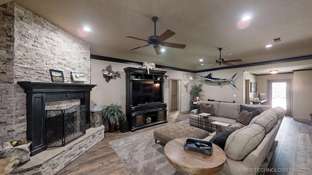 6166 Hedges St, Ardmore, OK 73401 - living room featuring ceiling fan, wood finished floors, a fireplace, recessed lighting, and ornamental molding