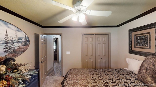 6166 Hedges St, Ardmore, OK 73401 - bedroom featuring ornamental molding, light wood finished floors, a closet, ceiling fan, and a textured ceiling
